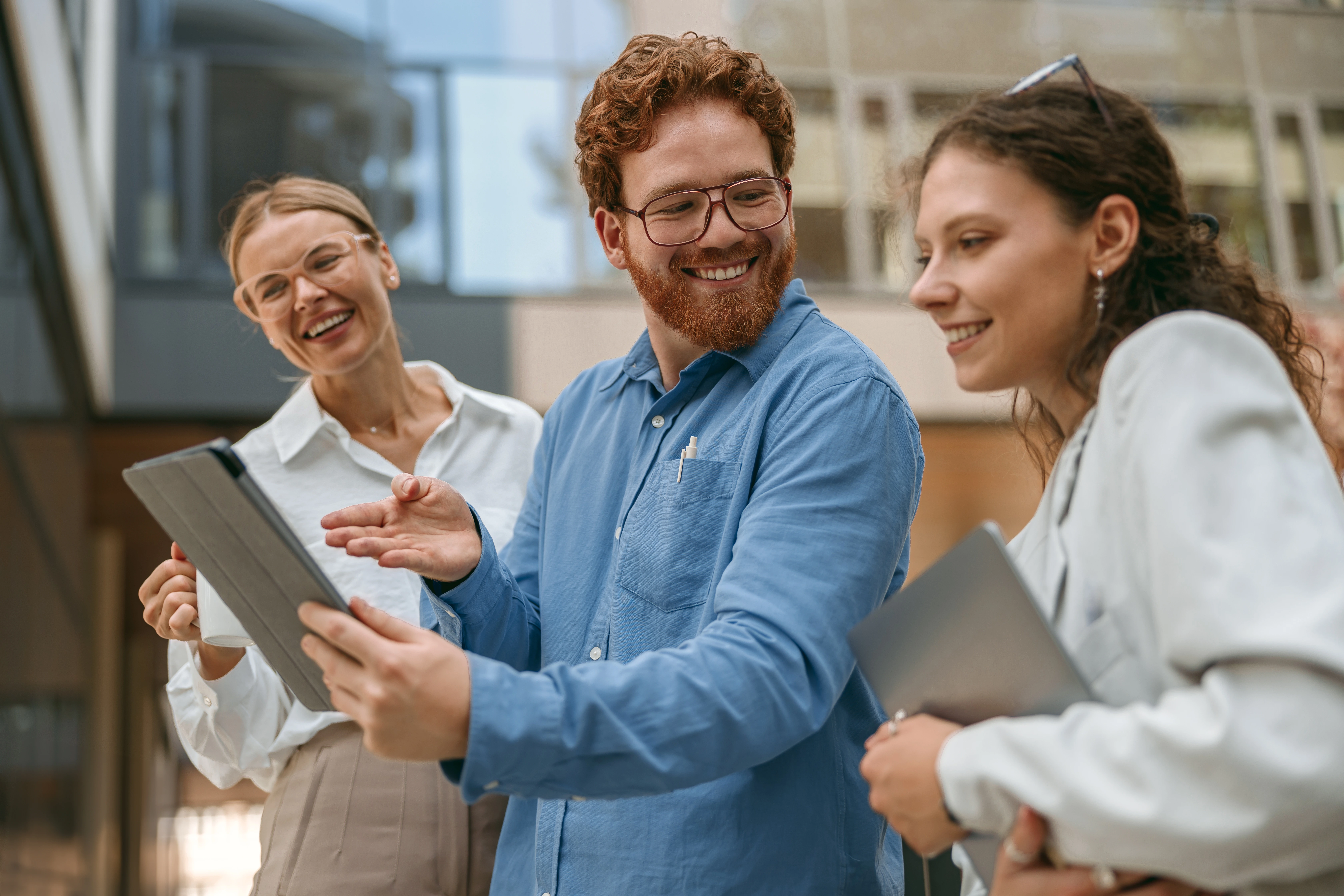 Happy employee engaging with colleagues in a modern, flexible work environment