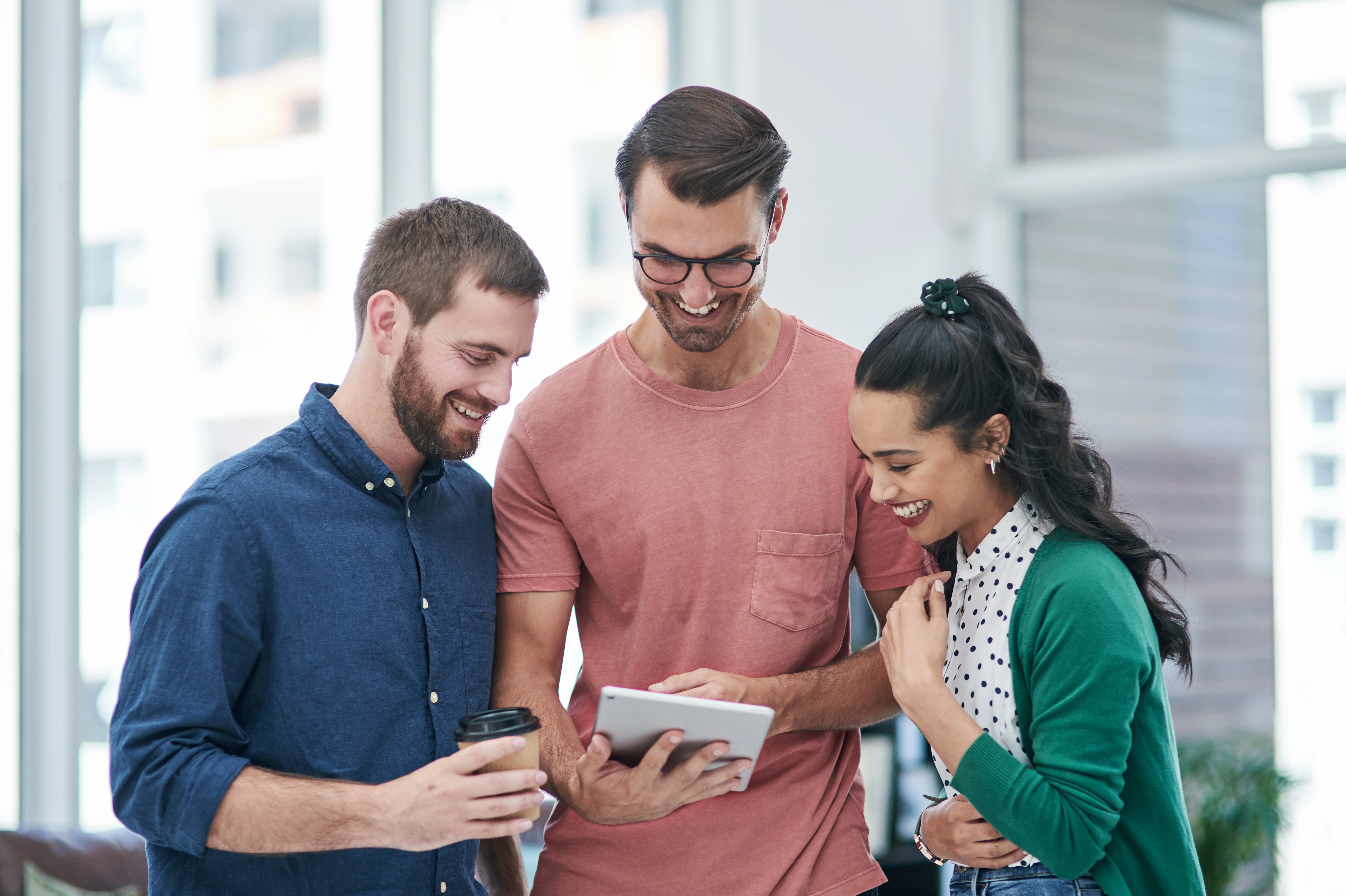Employees using an intranet platform on mobile, tablet, and desktop to stay connected and informed