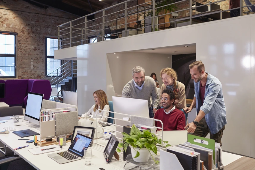 Team collaborating in a positive work environment with strong teamwork