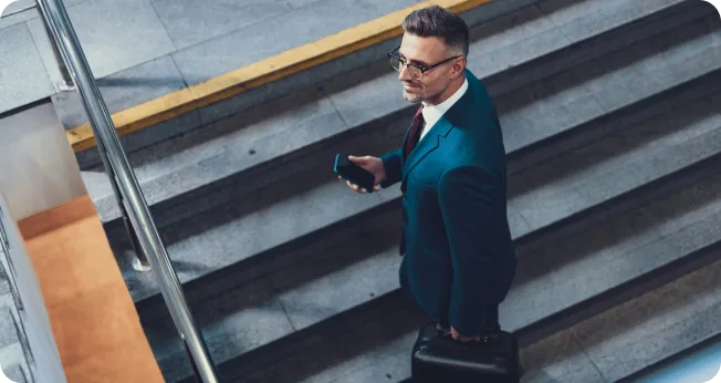 Professional businessman discusses Company Formation in Dubai on modern stairs