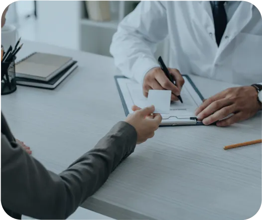 Company Formation In Dubai: Business professionals exchanging documents at office desk
