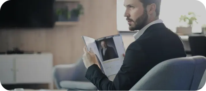 Free Zone In Dubai: Businessman reviews document in modern office setting