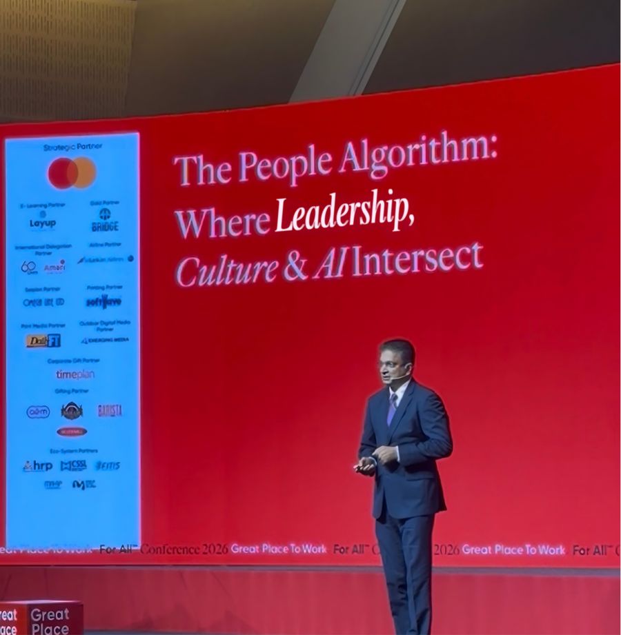 A speaker presenting “The People Algorithm” session on stage at the Great Place To Work® Conference, run on Layup.