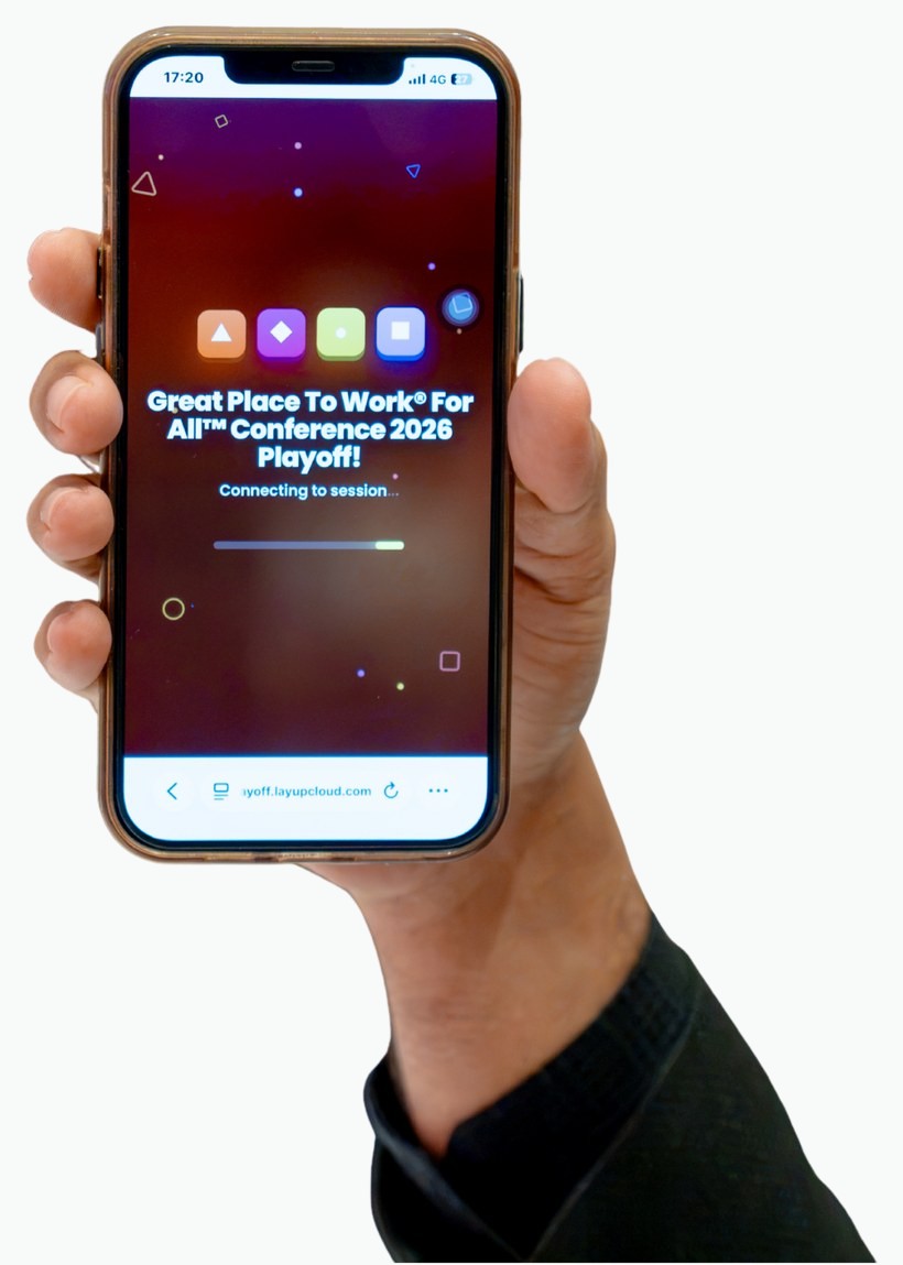 A delegate holding up his phone, connecting to a live session on the platform.
