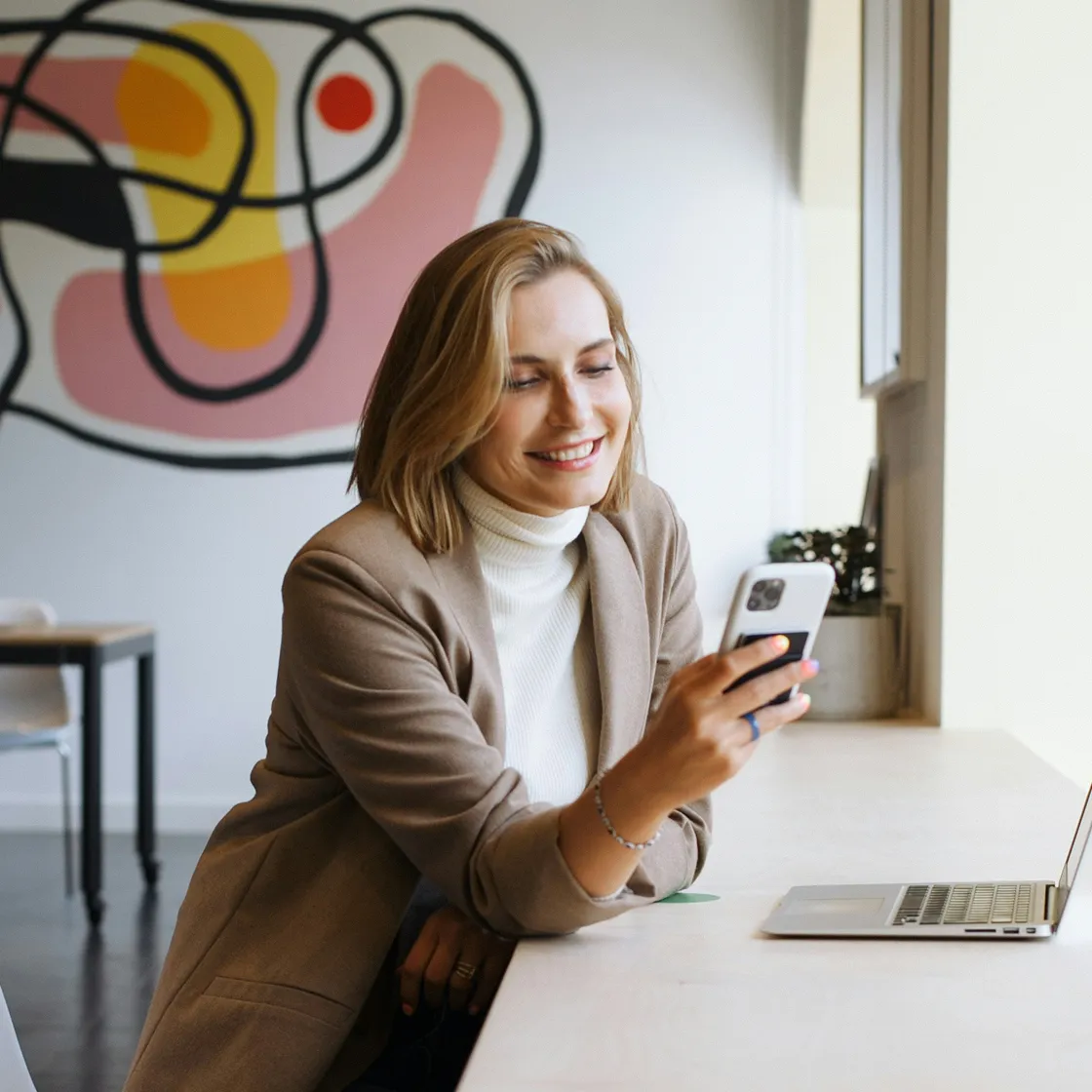 A man with a beard and a black shirt is smiling and celebrating.