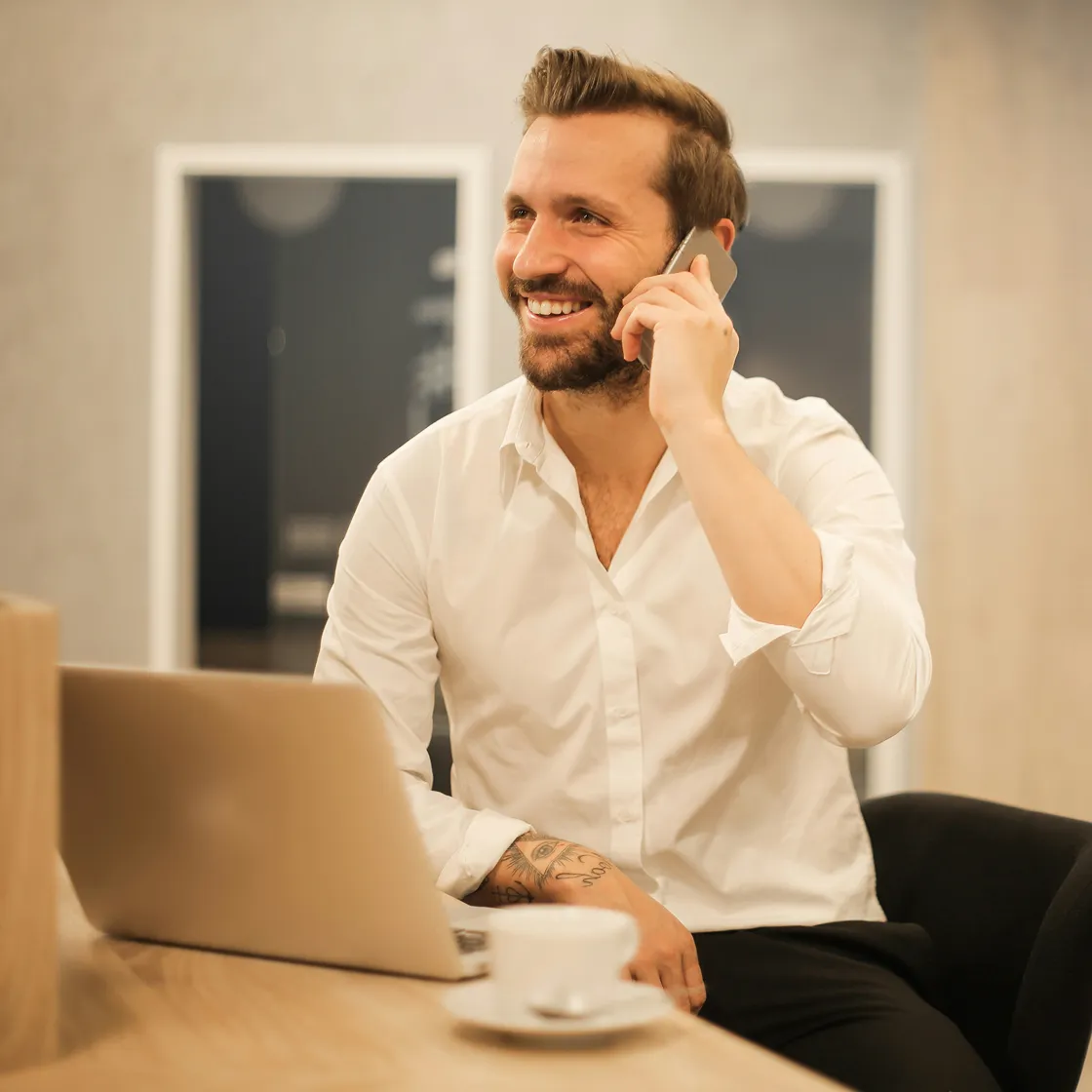 A man wearing sunglasses and a white shirt.