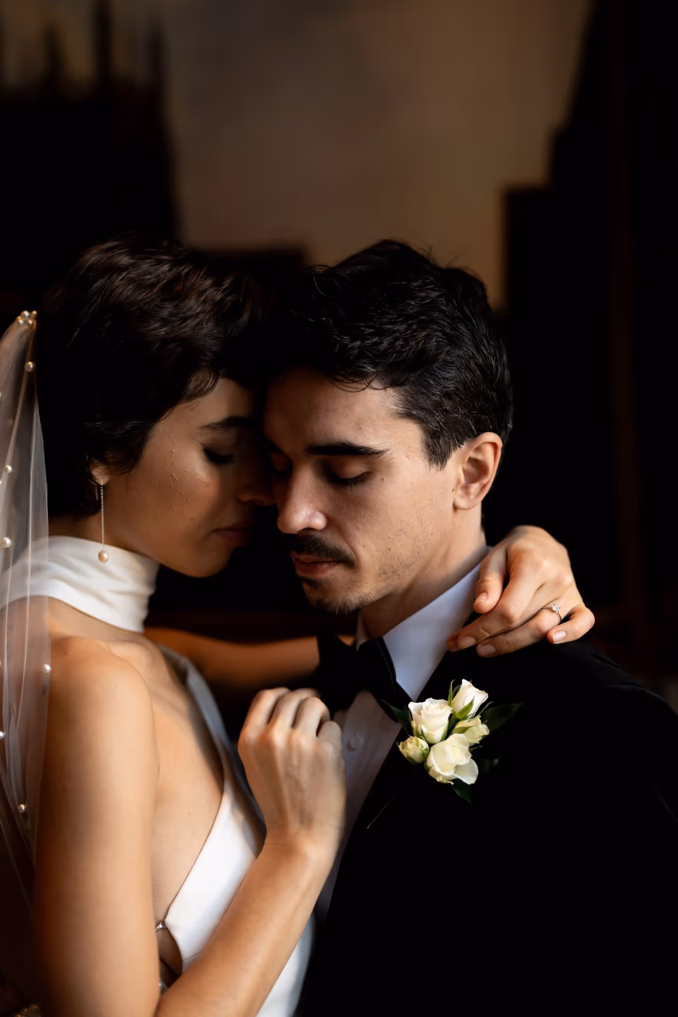 Close up shot of bride and groom embracing