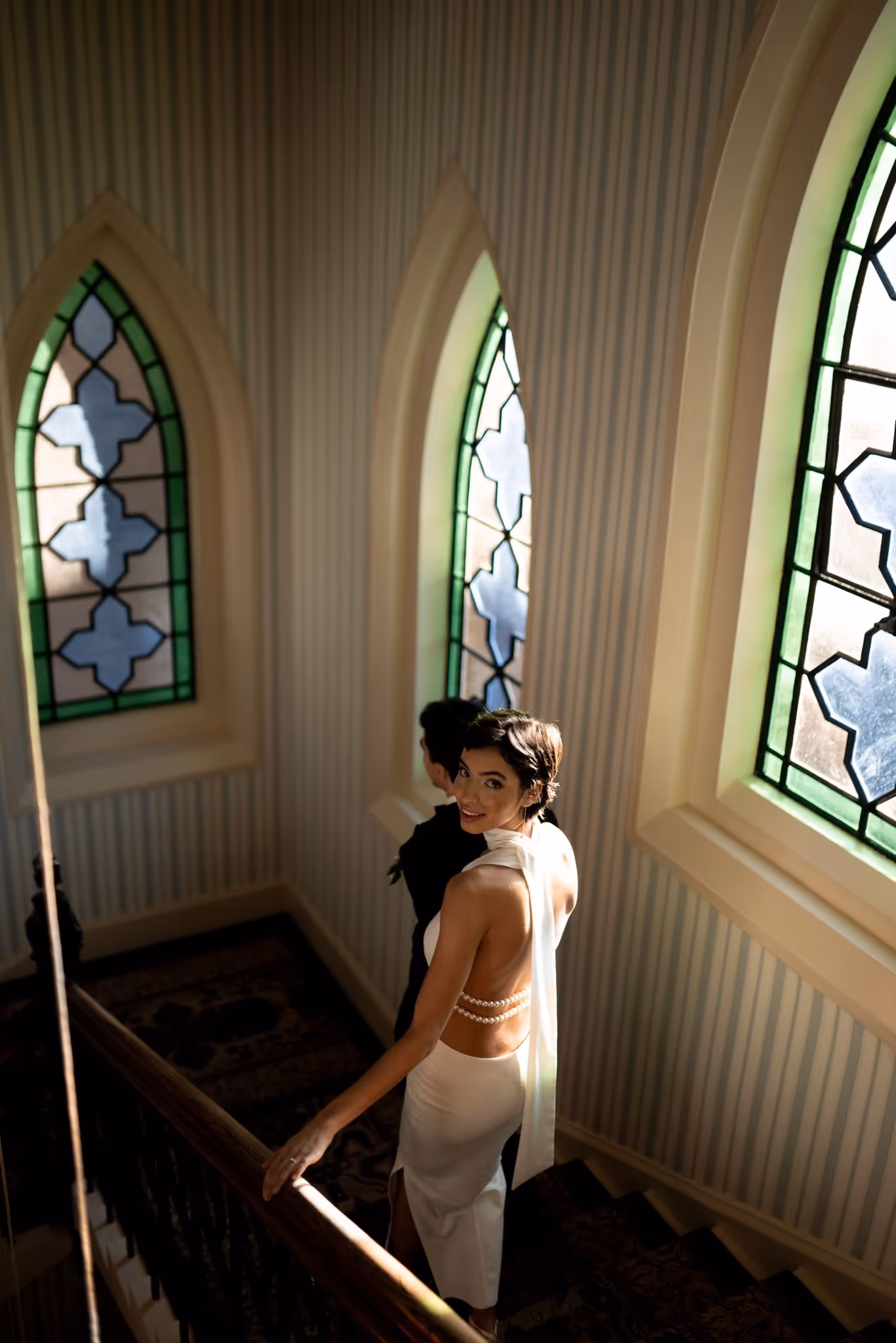 Bride and groom walking down stairs