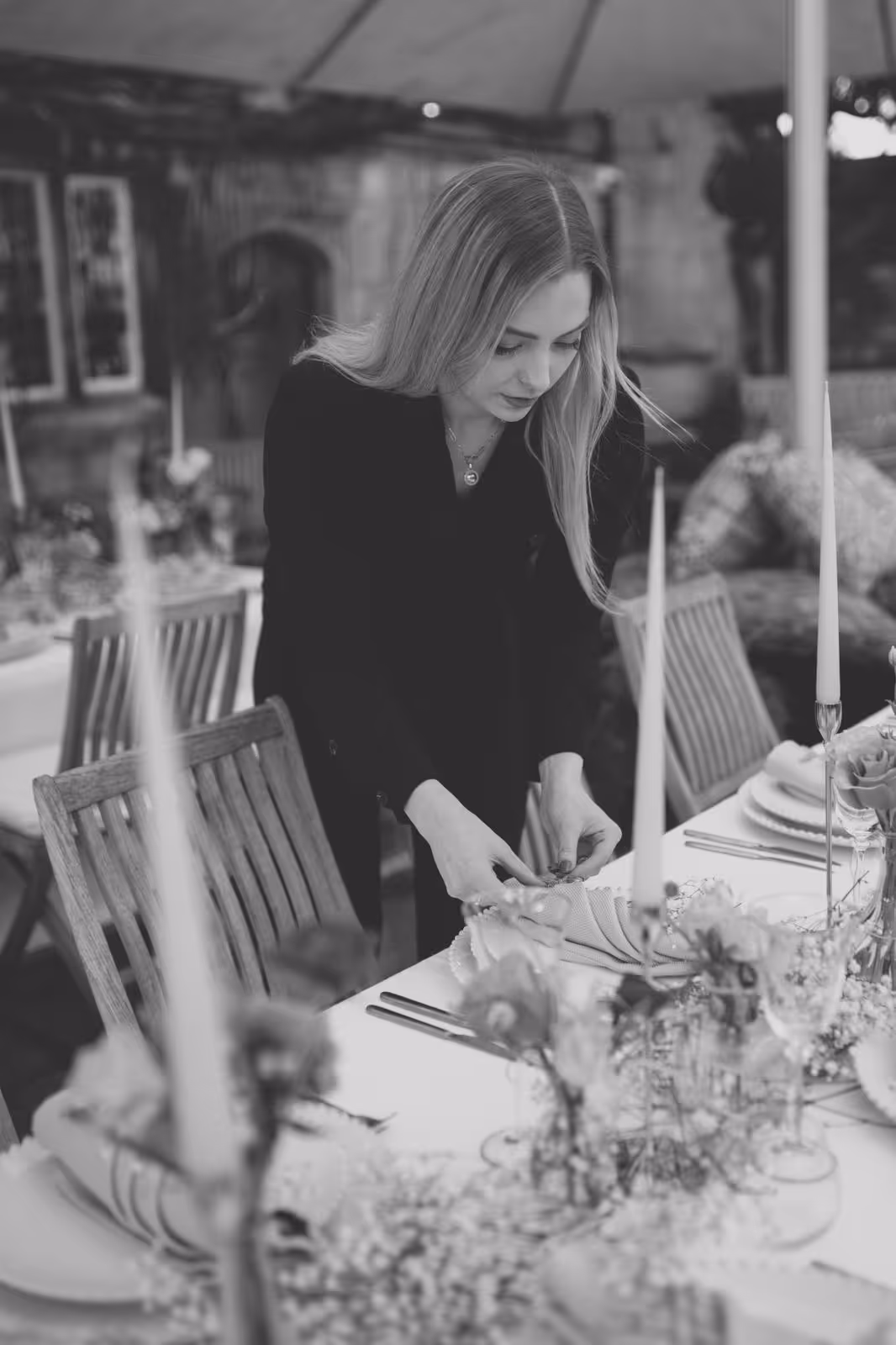 Wedding planner arranging place settings for wedding breakfast