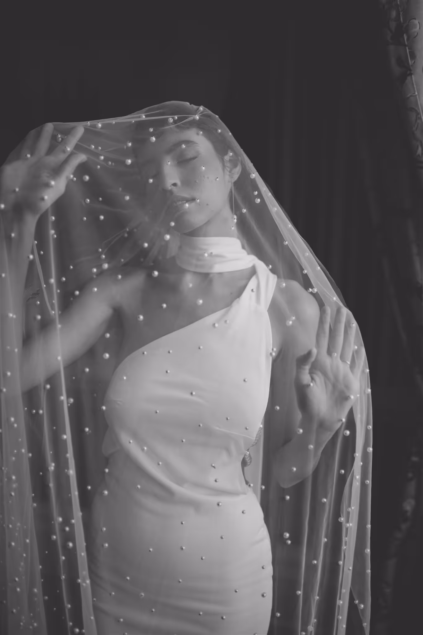 Bride in white dress under pearl veil