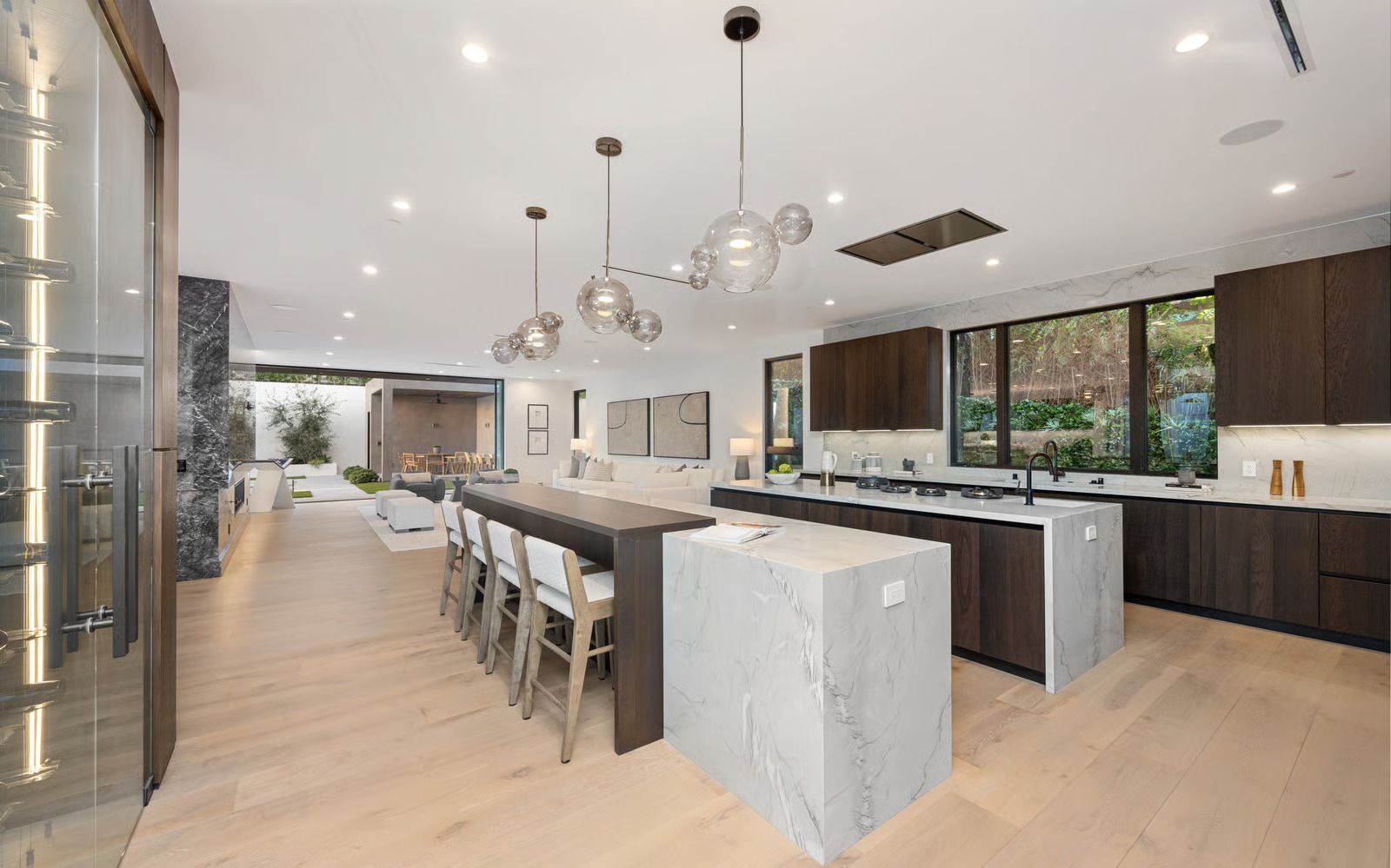 statement lighting for kitchen island with linear chandelier over oversized marble island