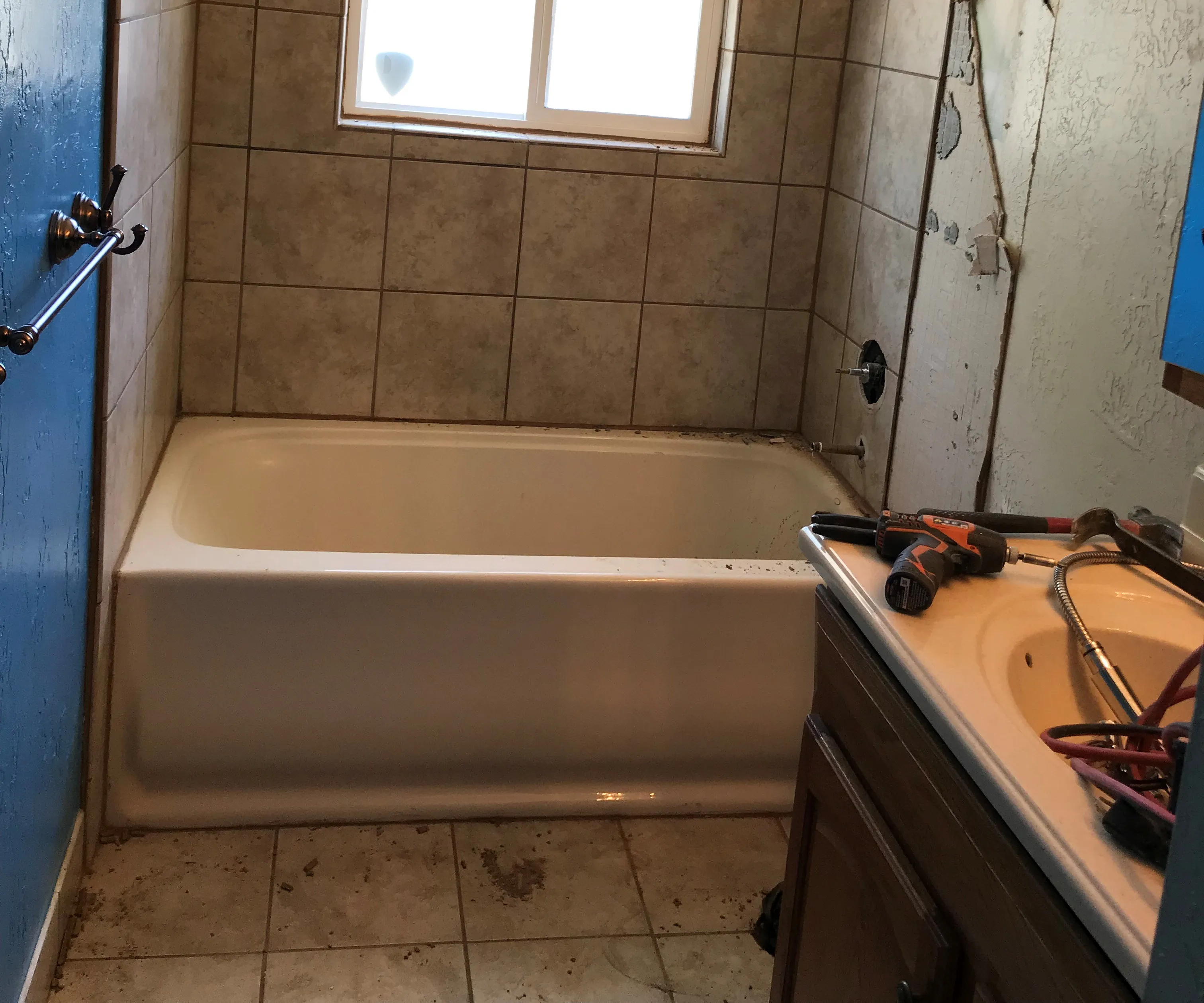 Modern bathroom renovation in Park City with sleek white tiles and a glass shower enclosure.