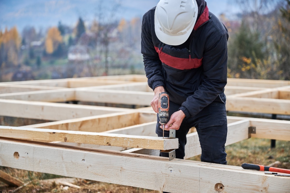 Home remodeling contractor holding a drill during deck construction in a Salt Lake City home