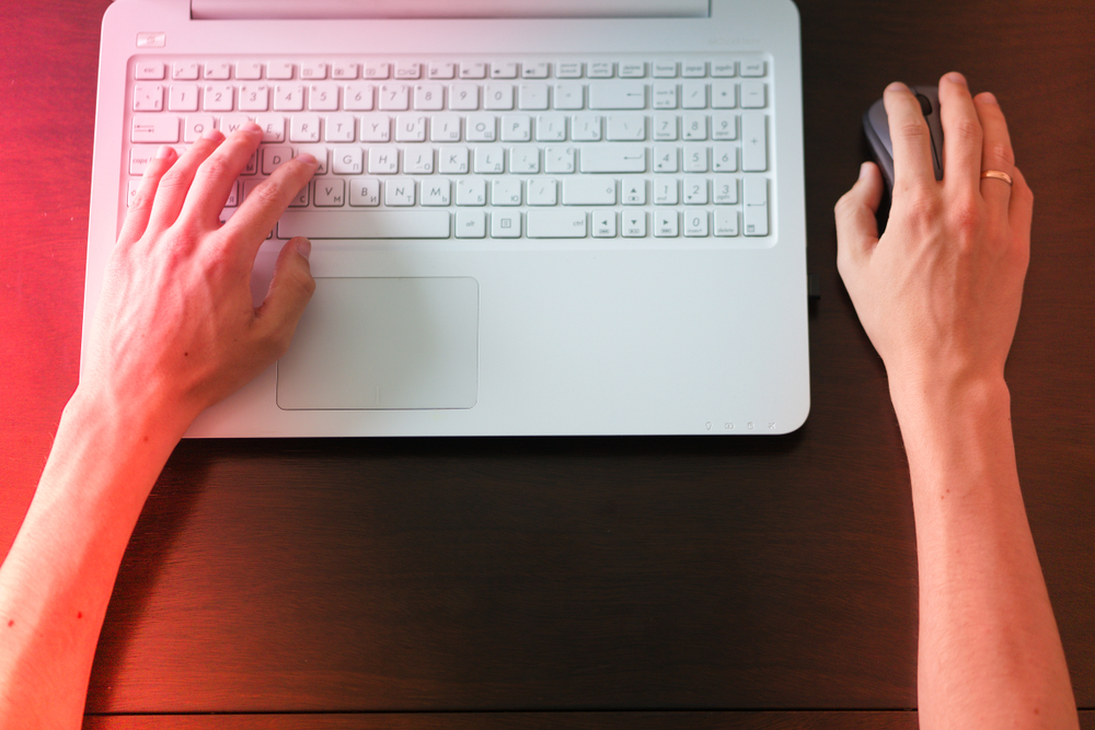 Person documenting evidence after discovering revenge porn shared without consent.