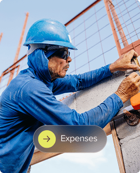 Man in a hard hat measuring and marking a frame..