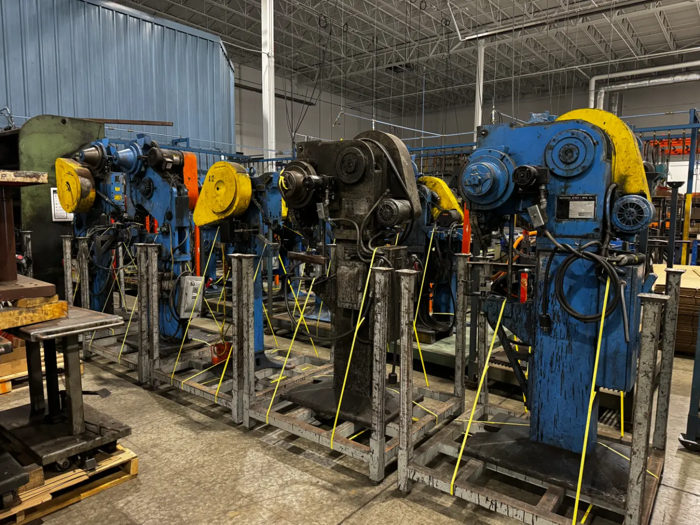Row of riveters and presses, machine shop – Rize Home surplus auction, Solon OH