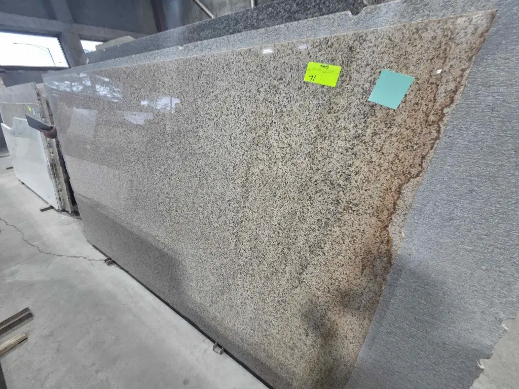 Granite and marble slab inventory on A-frame racks at Stone City auction, Chicago IL