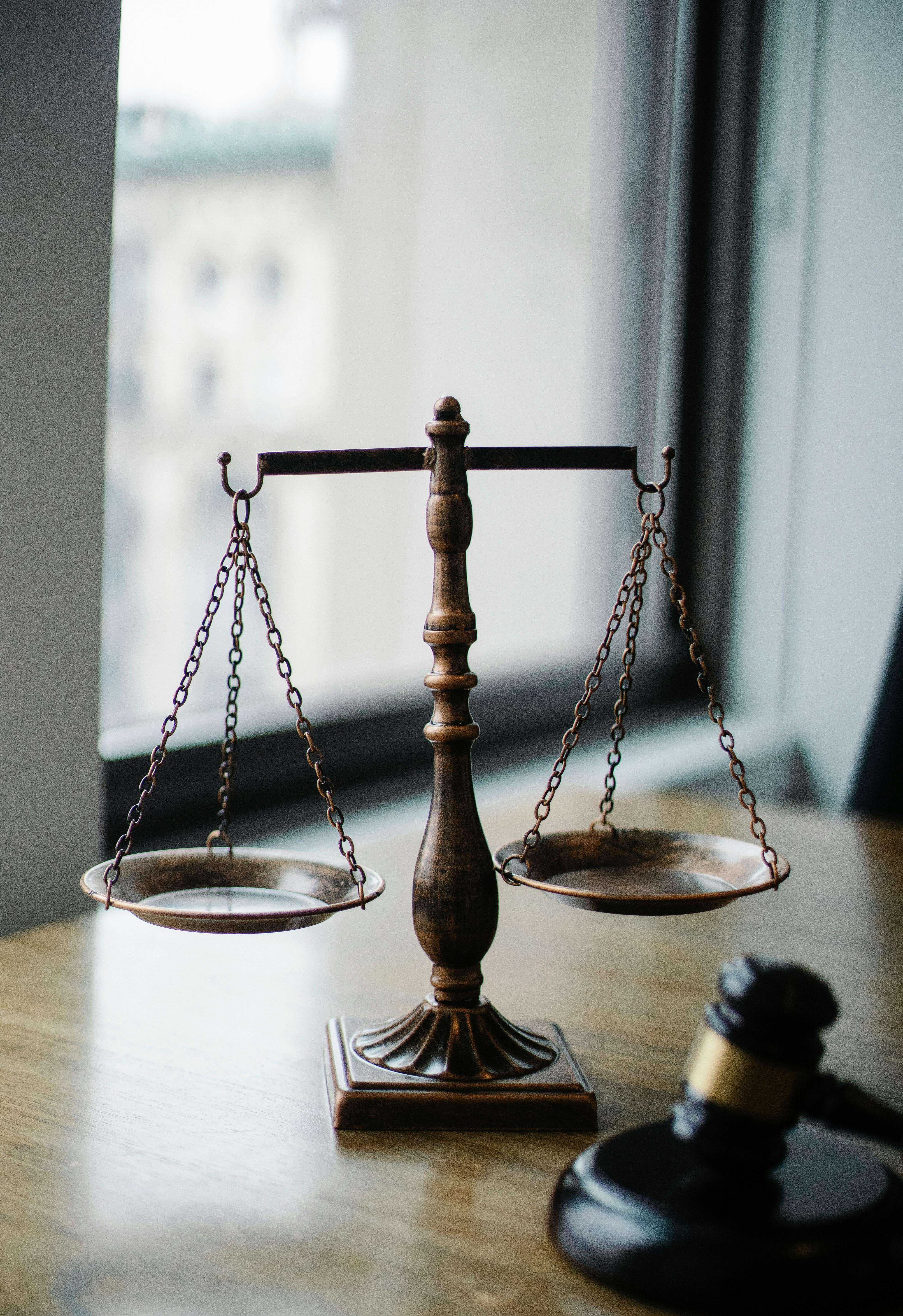 Empty balance scale next to a gavel.  Good judgment is serious business.