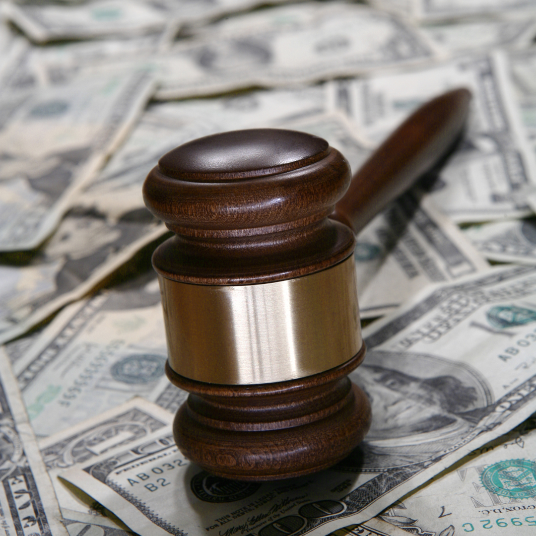 A gavel resting on top of cash