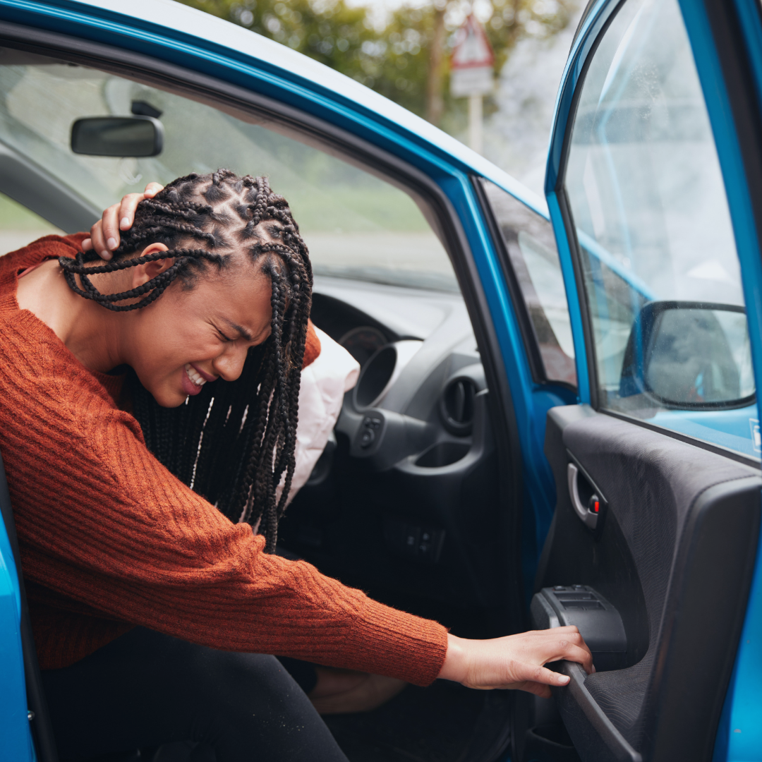 Woman holding her neck in pain after a car accident