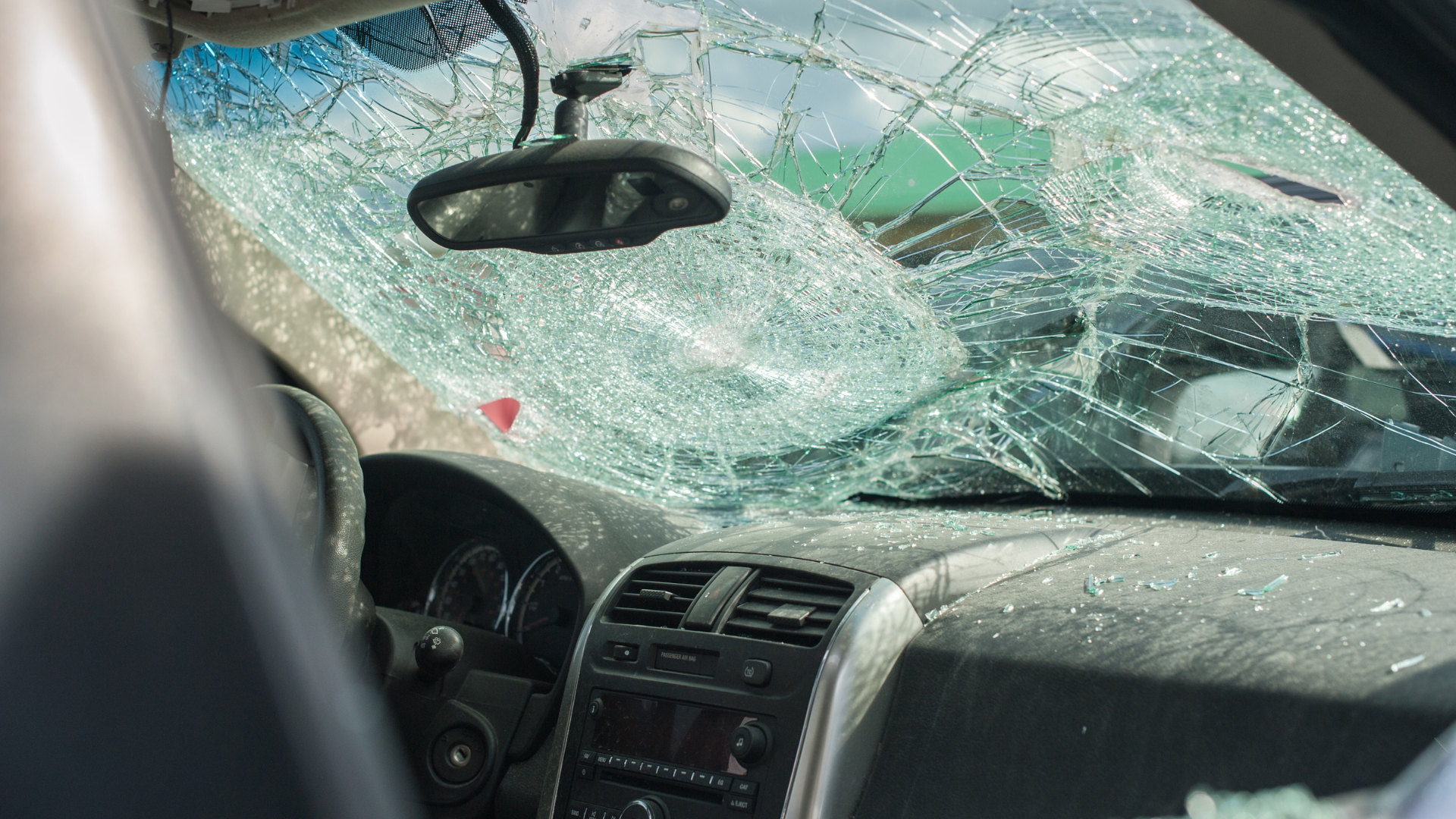 A smashed up windshield of a car after a collision