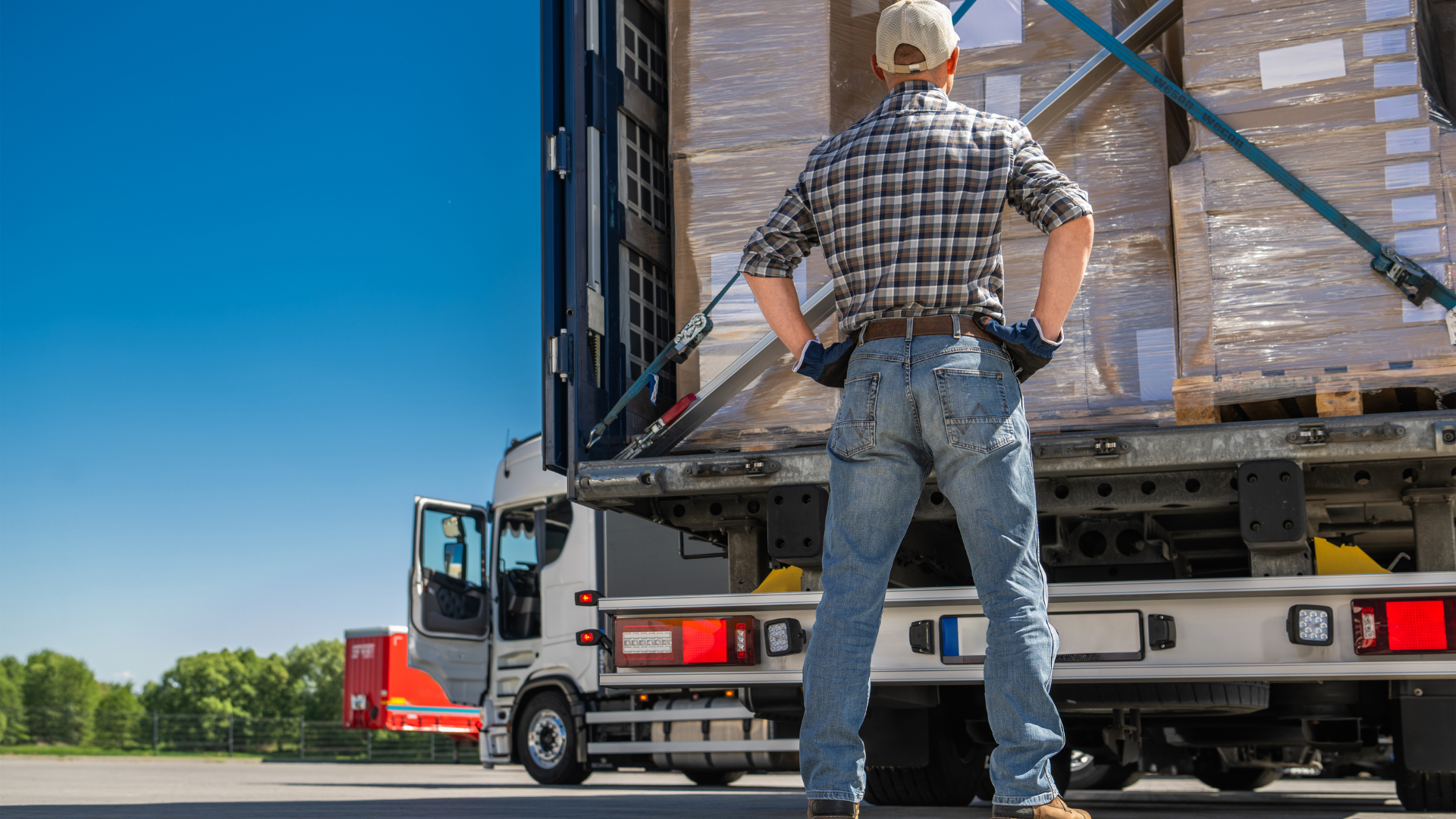A truck driver inspecting the cargo load of a trailer