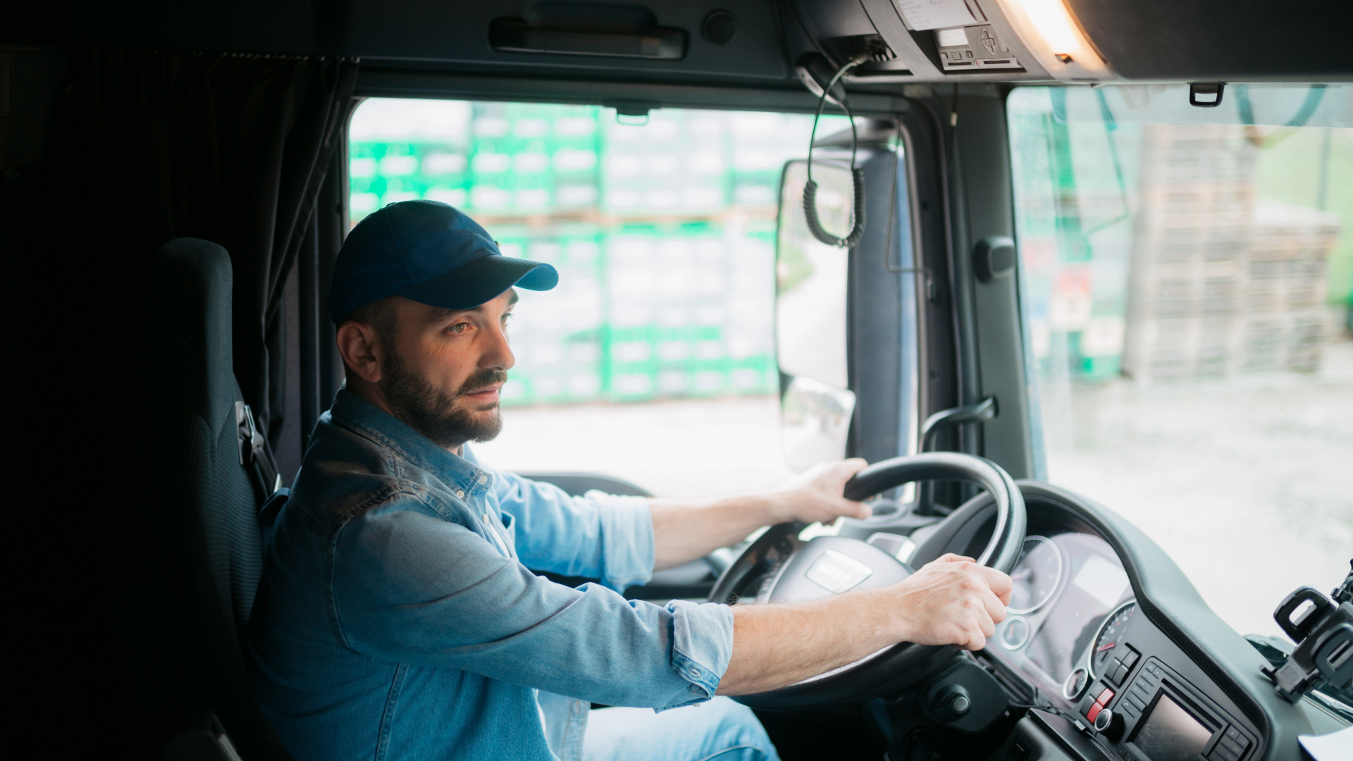 A truck driver in the cab of his truck
