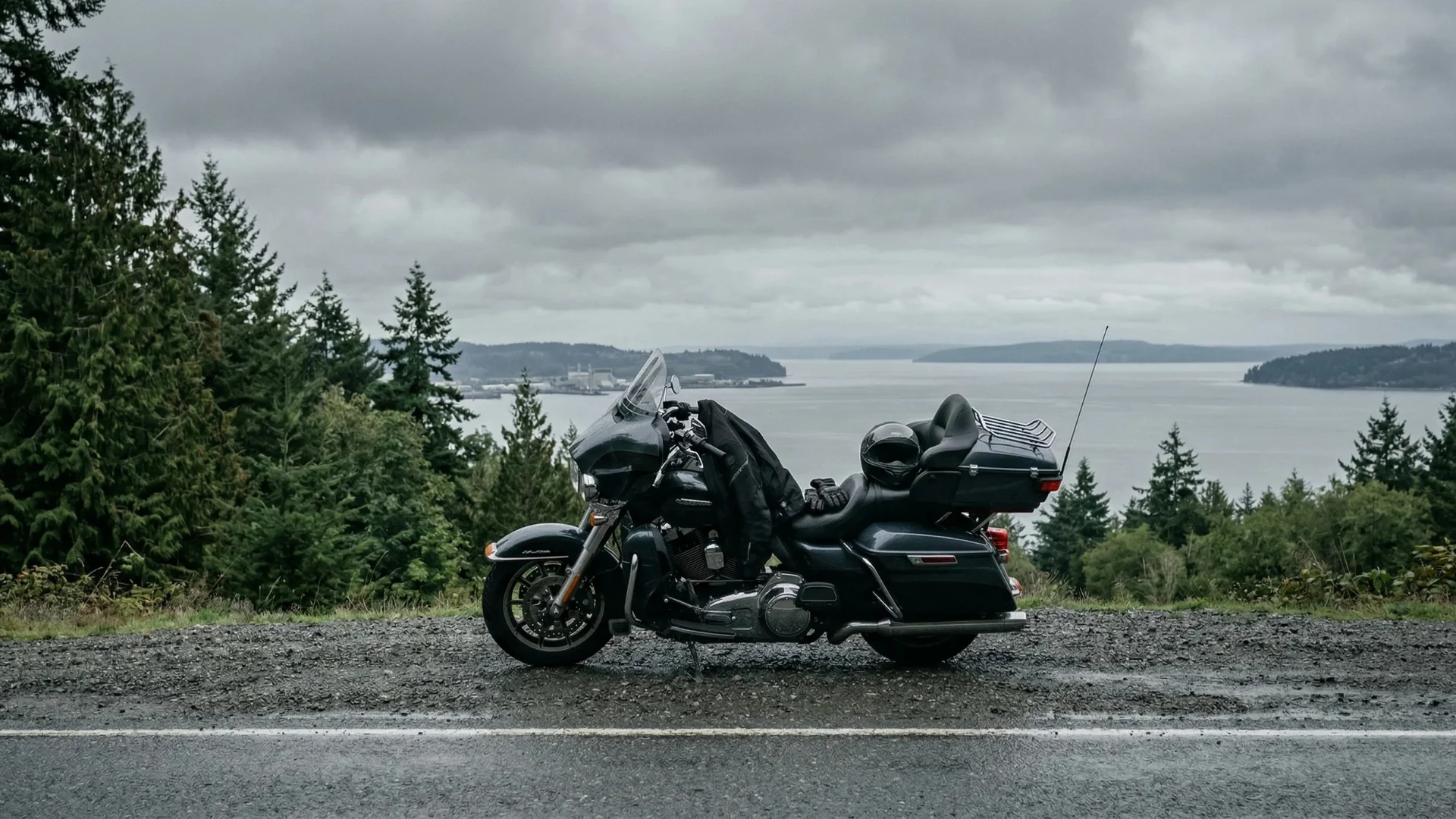 Motorcycle parked on the side of the road in Washington on a wet overcast day near Puget Sound