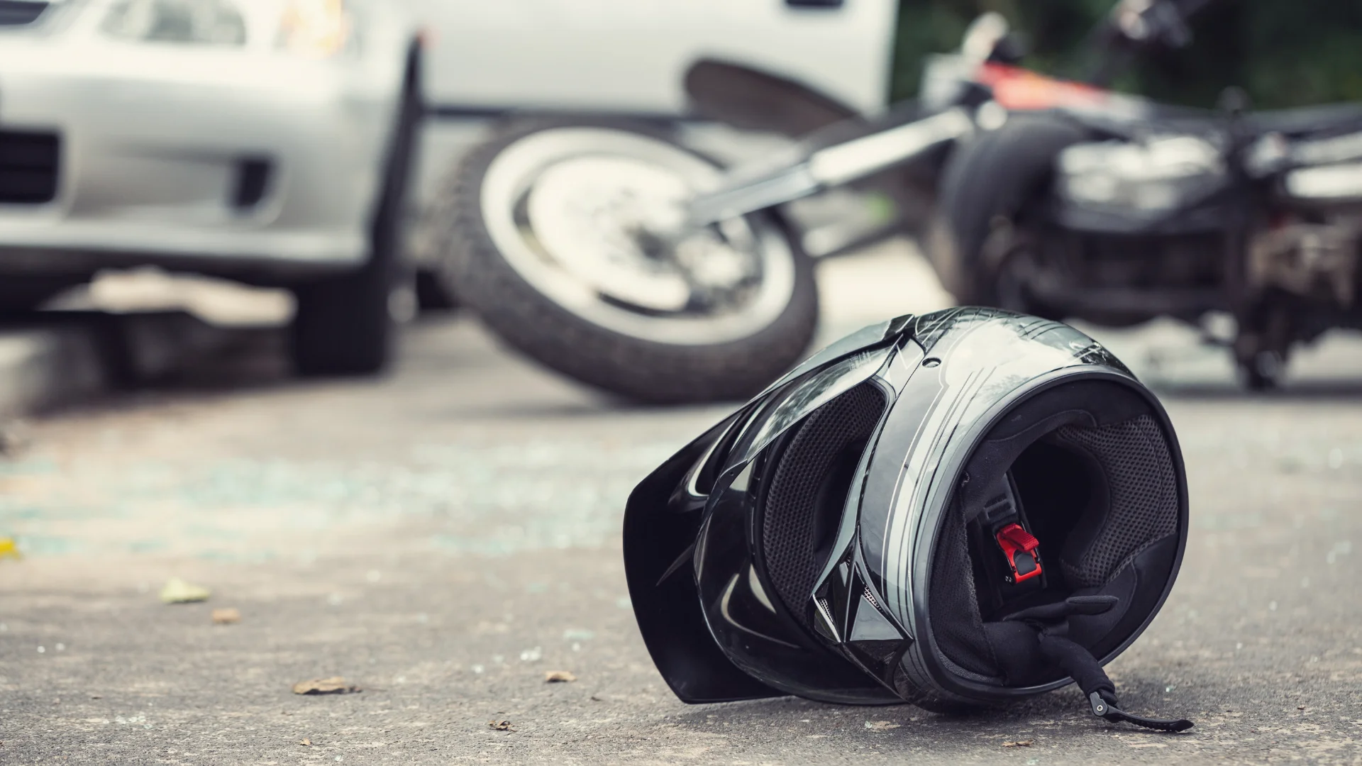 A motorcycle helmet resting on the ground after a motorcycle crash