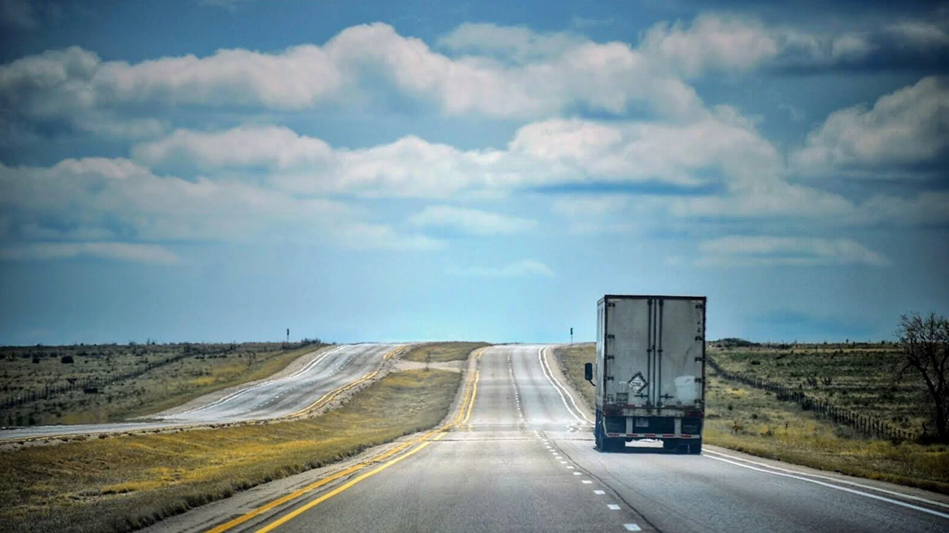 A lone semi truck hauling a trailer on Interstate 80