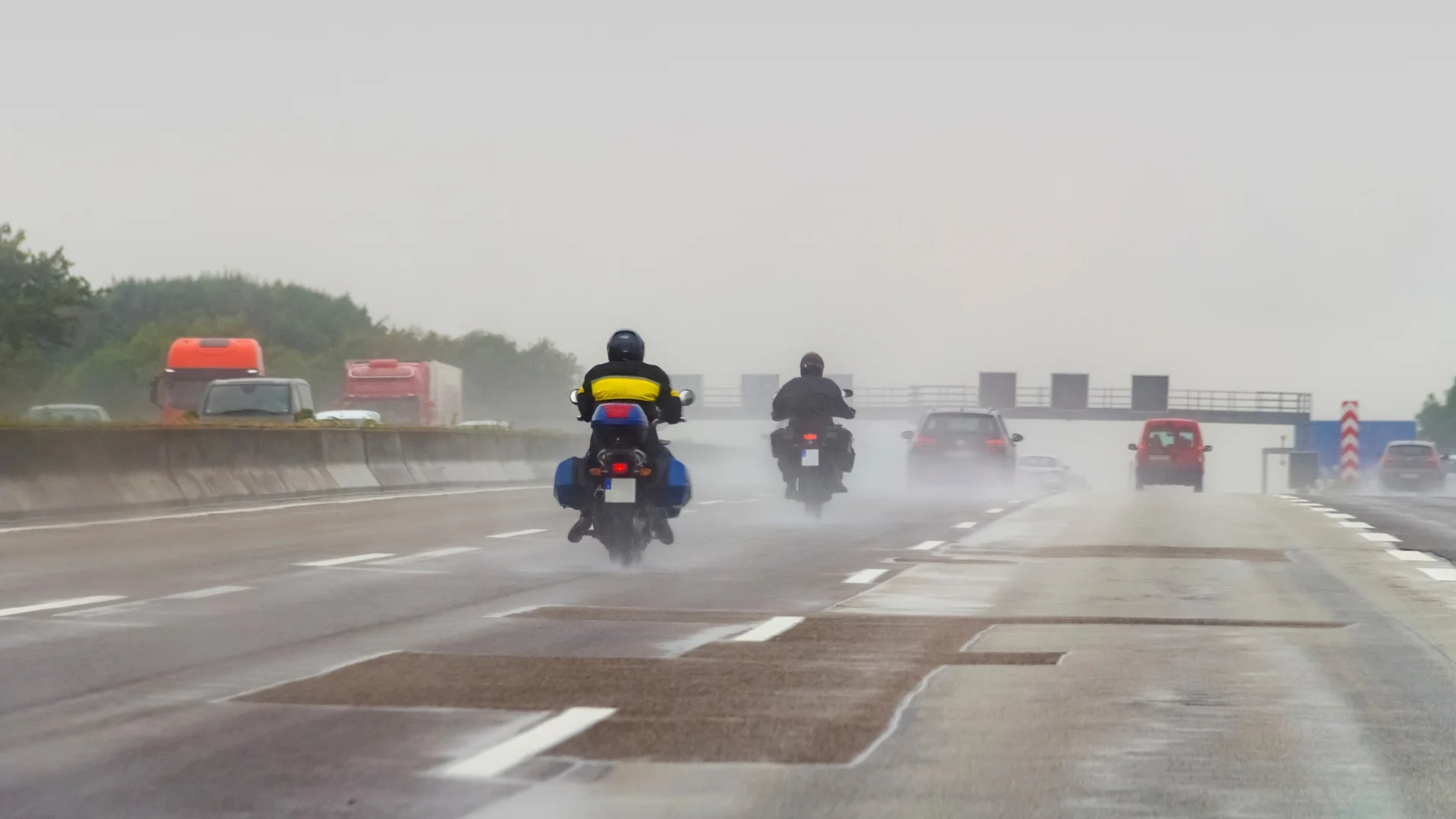 Motorcyclists riding in the rain on the freeway