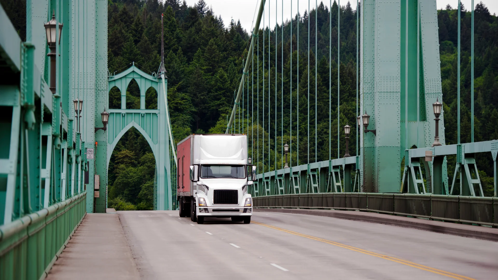 A white semi truck on St John's Bridge near Portland