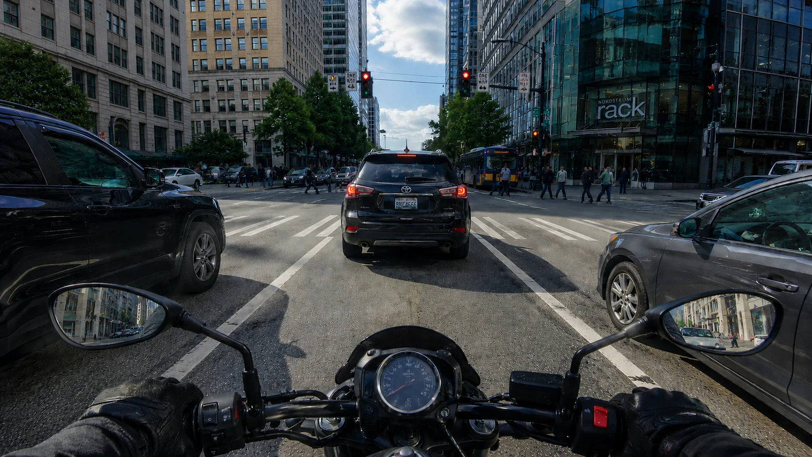 A motorcyclist stopped at a busy intersection