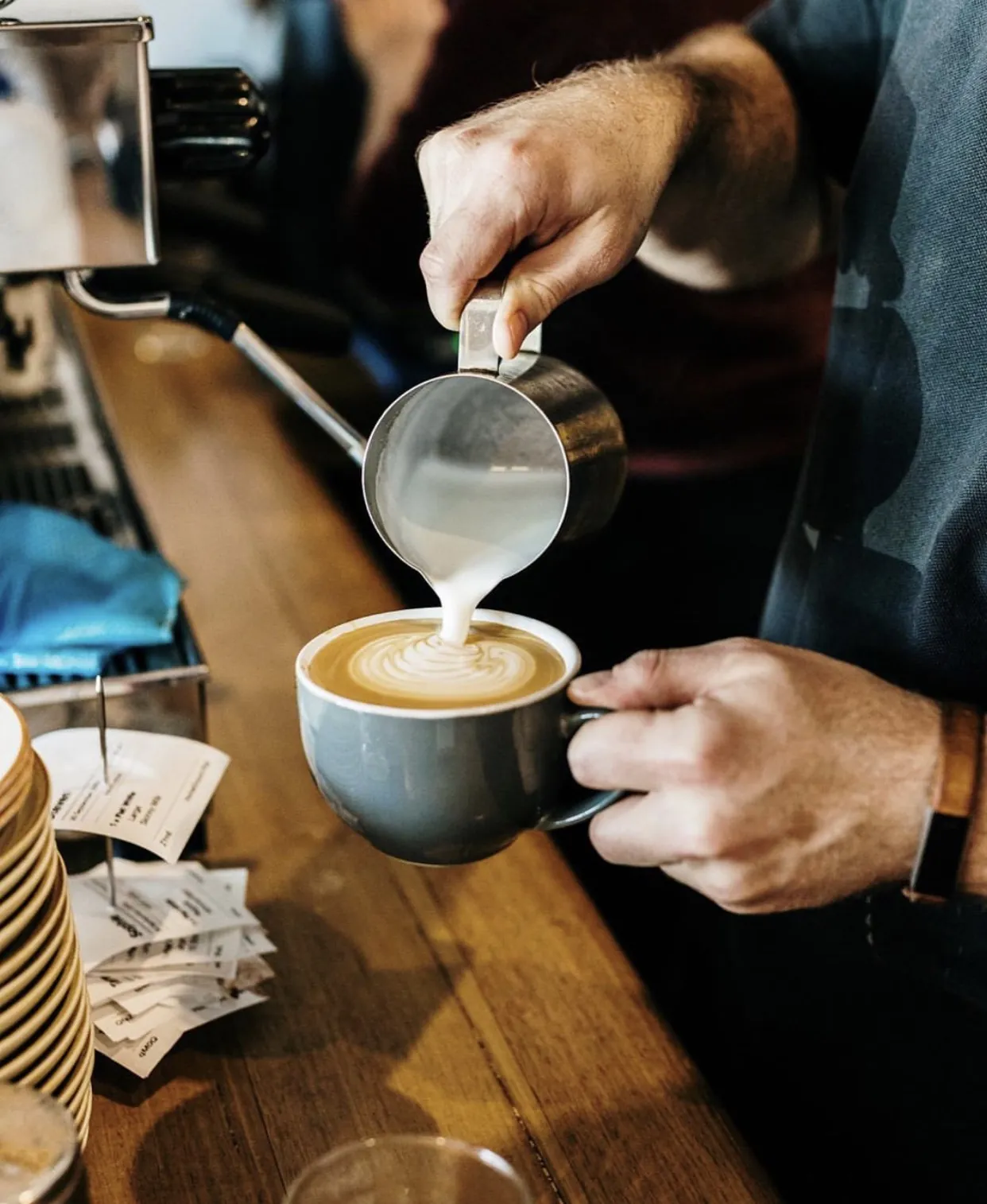 Latte art being poured at HomeGround Café