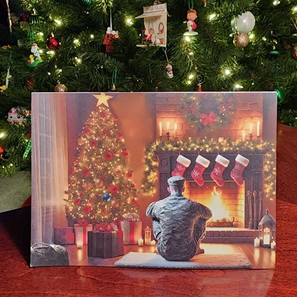 This touching Christmas card captures a moment of quiet anticipation and heartfelt joy. The scene features a soldier, home for the holidays, his duffel bag resting by the door as he sits in front of a glowing fireplace and a beautifully decorated Christmas tree. In this tender moment of peace, he takes in the warmth of home, knowing his family is just moments away from the greatest gift of all—his return. Titled "All is Calm," this card beautifully captures the magic of reunion and the unspoken gratitude of having loved ones safe and near. Perfect for honoring those who serve and celebrating the joy of homecoming during the holiday season.