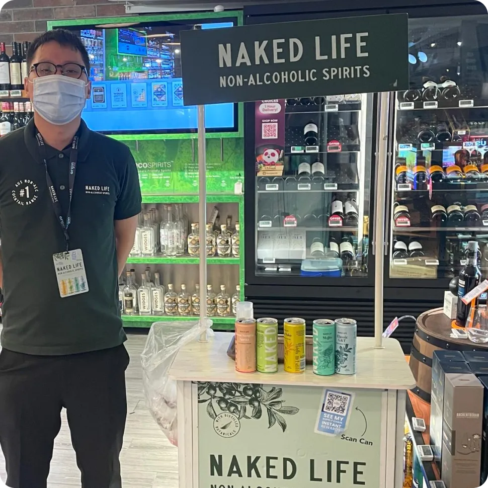 Naked Life non-alcoholic drink cans on display in a Singapore retail store