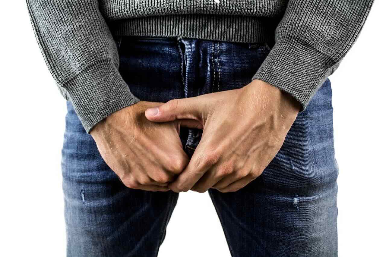 urological issue concept image - anonymous man holding penis
