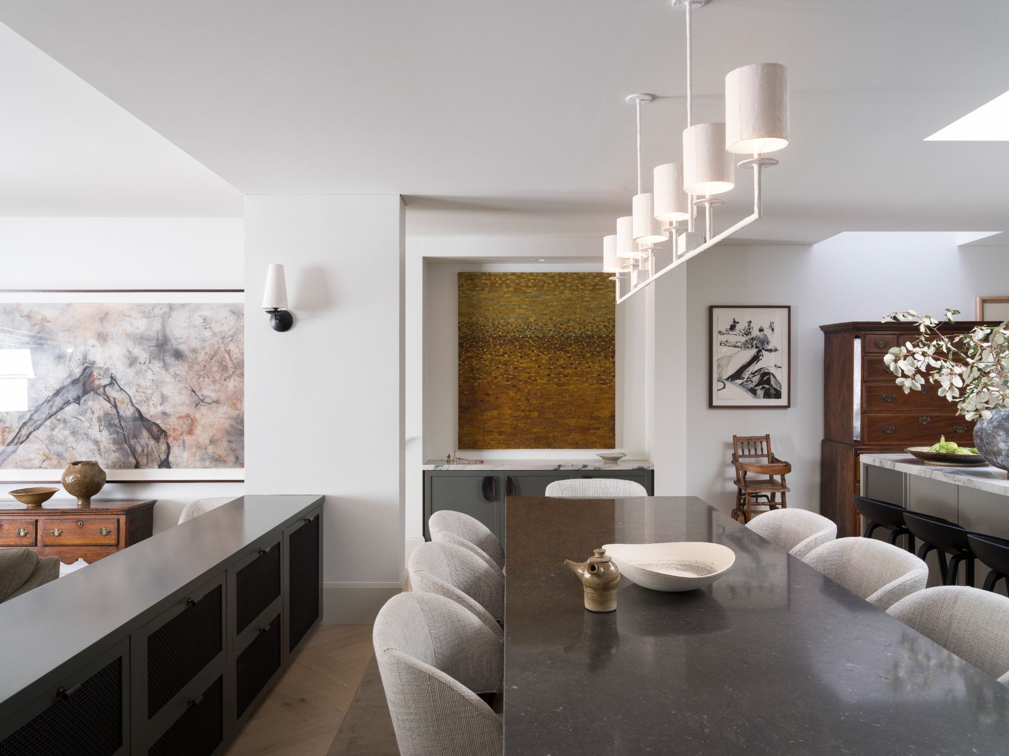 Bright Woollahra dining room with a white linear pendant light over a stone dining table, electrical by Better Electrical Co.
