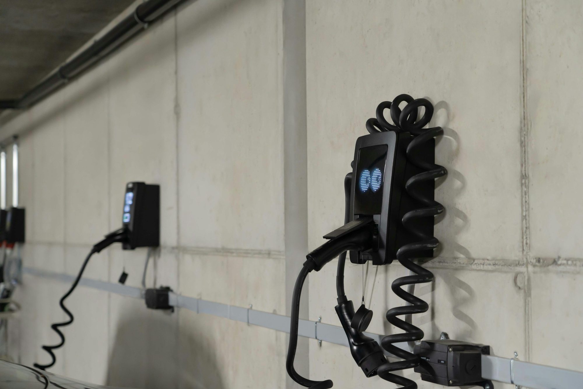 Wall-mounted EV chargers in a strata car park