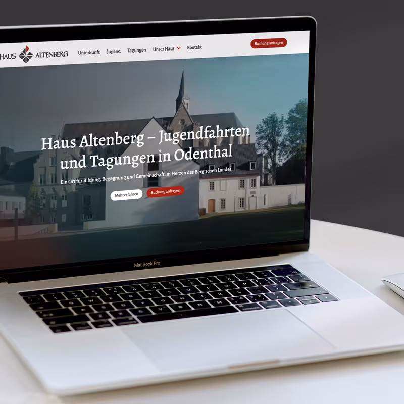 Preview of the Haus Altenberg web design project by Ruta Dambrauskaite, shown on a MacBook that is placed on the desk.
