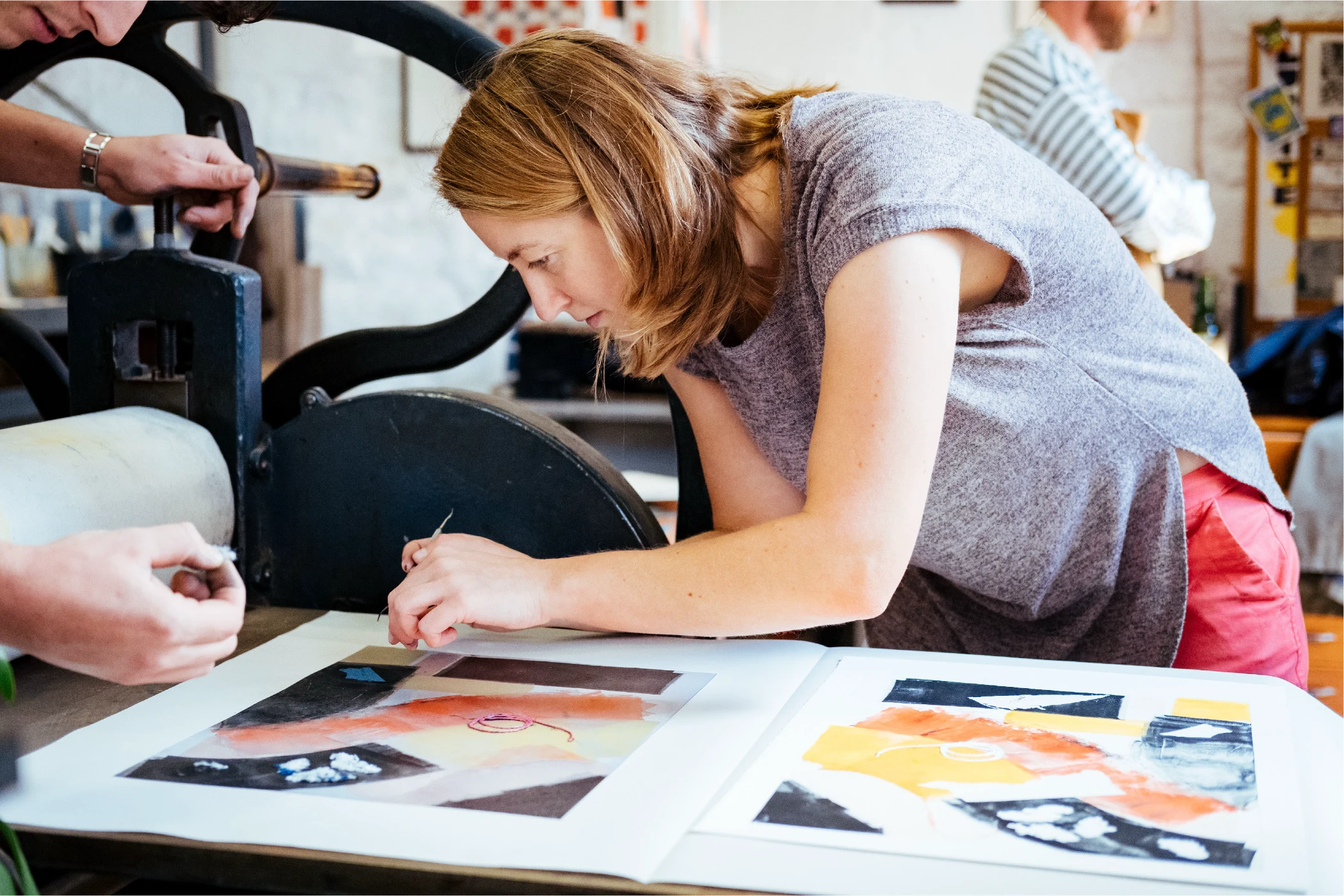 A woman is working on a piece of art