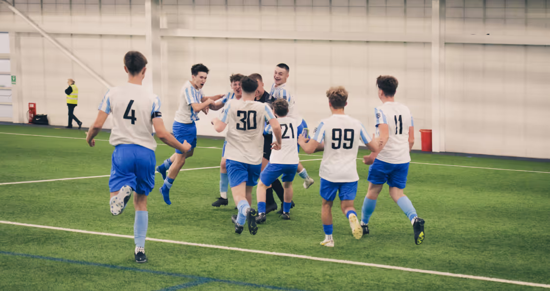 A group of footballers celebrating goal