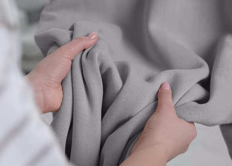 Woman holding fabric in her hands