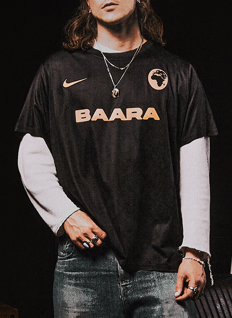 A man wearing a black shirt with the word BAARA on it.