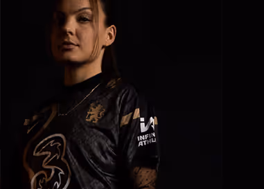 A woman wearing a black shirt with a bird on it.