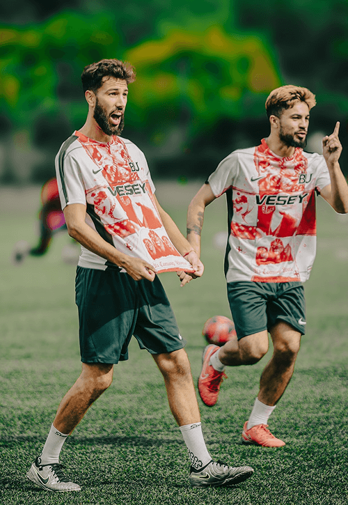 Two male football players on the football pitch