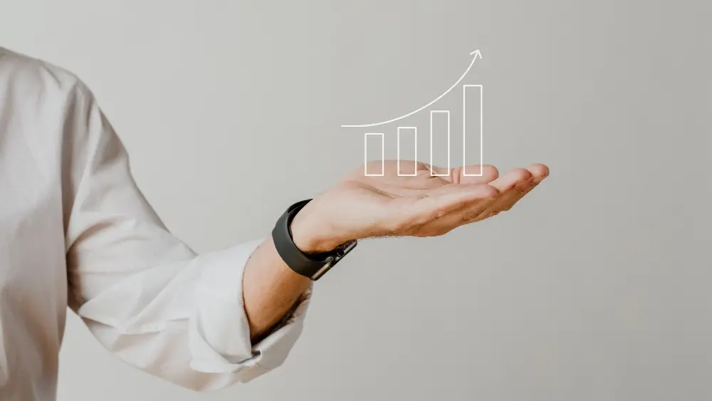 An open hand with a projected growth chart above.