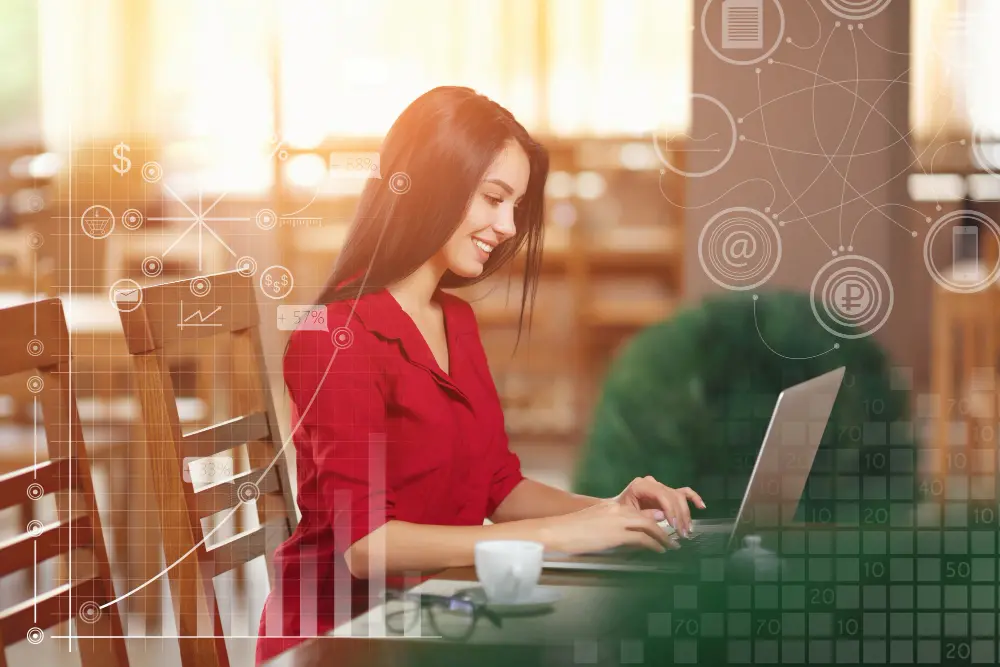 Mulher digitando em um laptop com gráficos digitais ao redor.