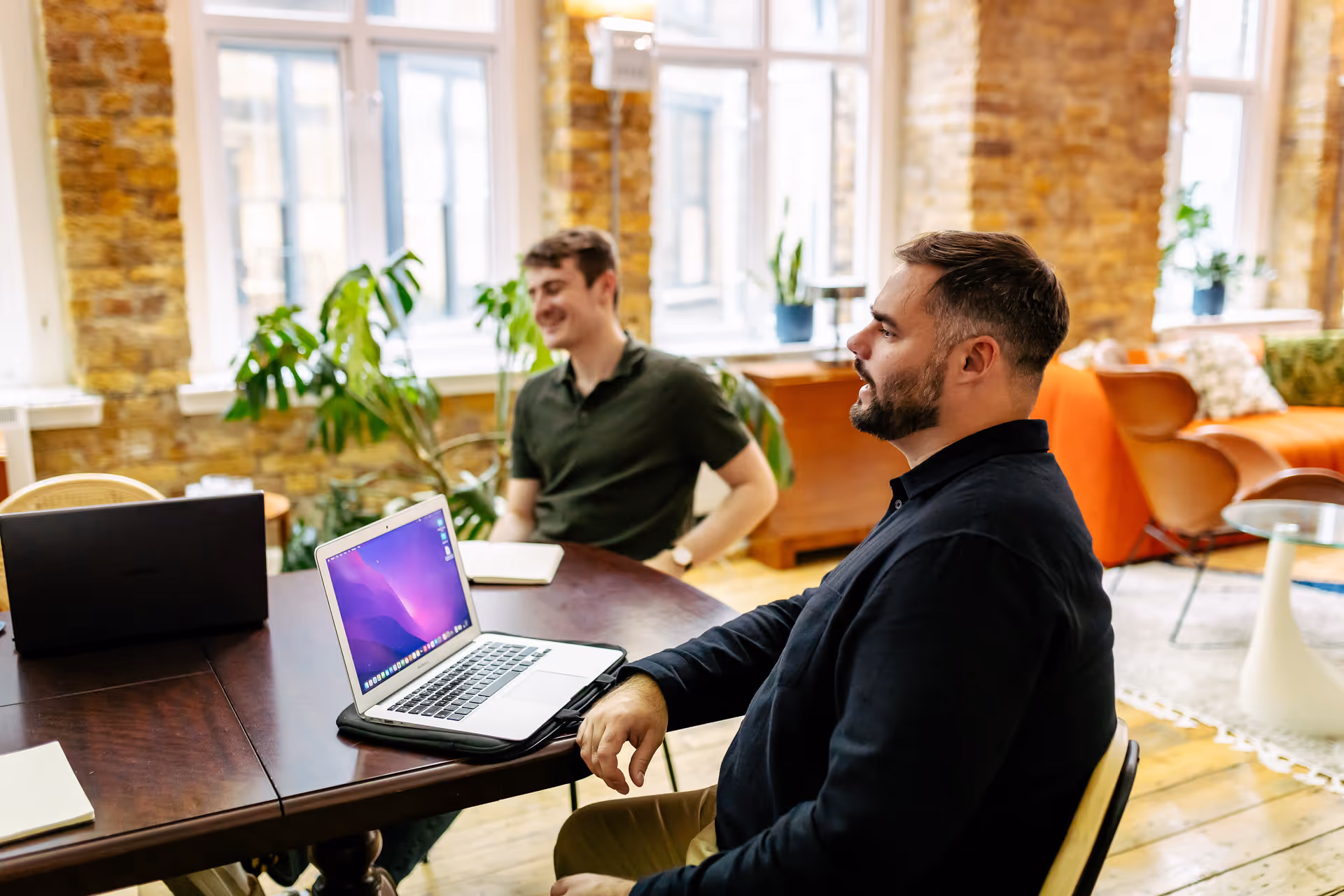 Two Team 4 members with laptops