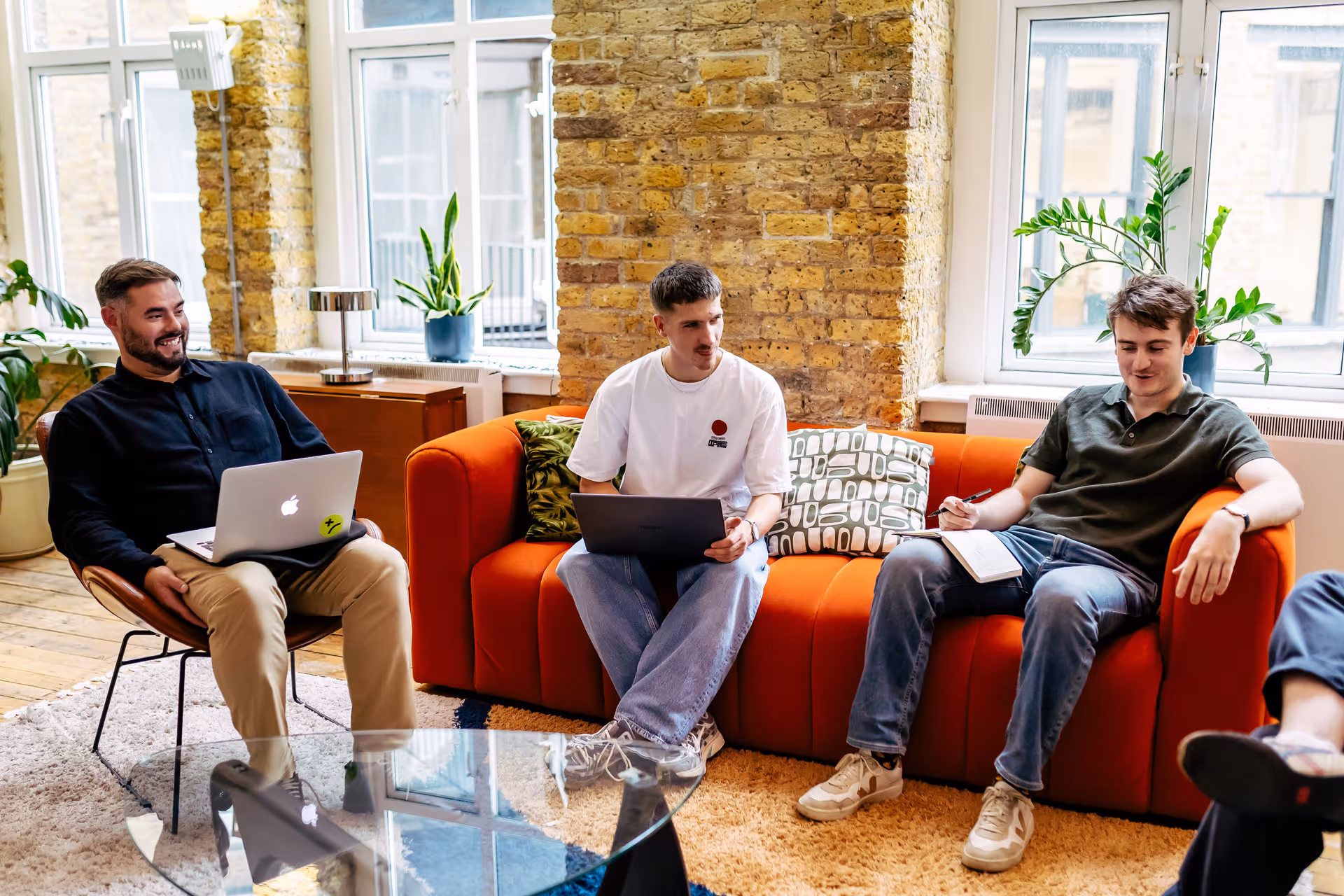Three Team 4 members sat on sofas working
